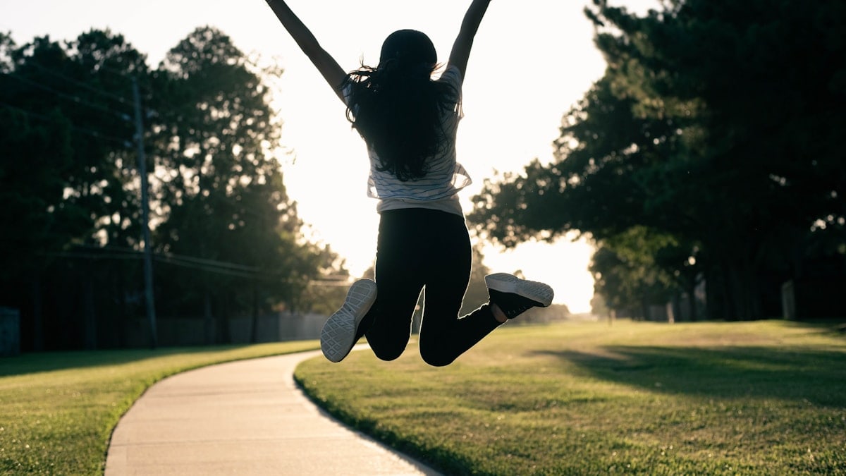 A person jumping in the air on a skateboard